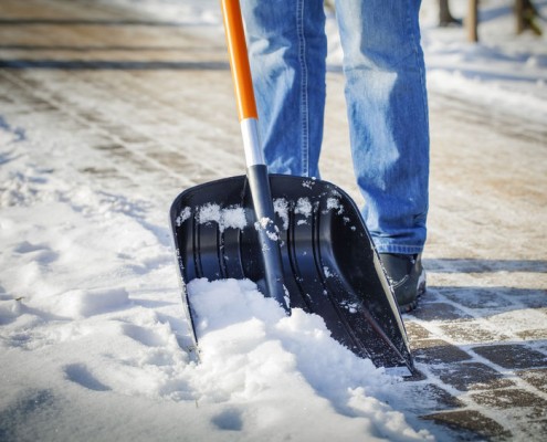 25868143 - man with snow shovel cleans sidewalks in winter