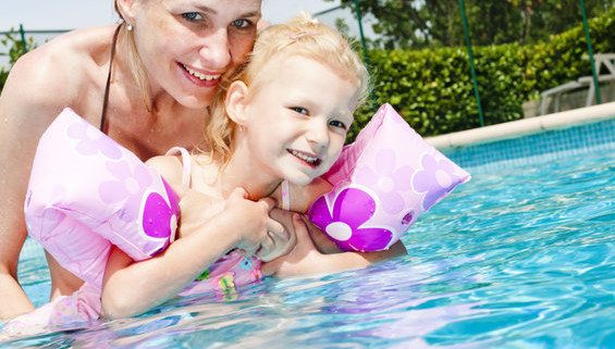 mother with her daughter in swimming pool